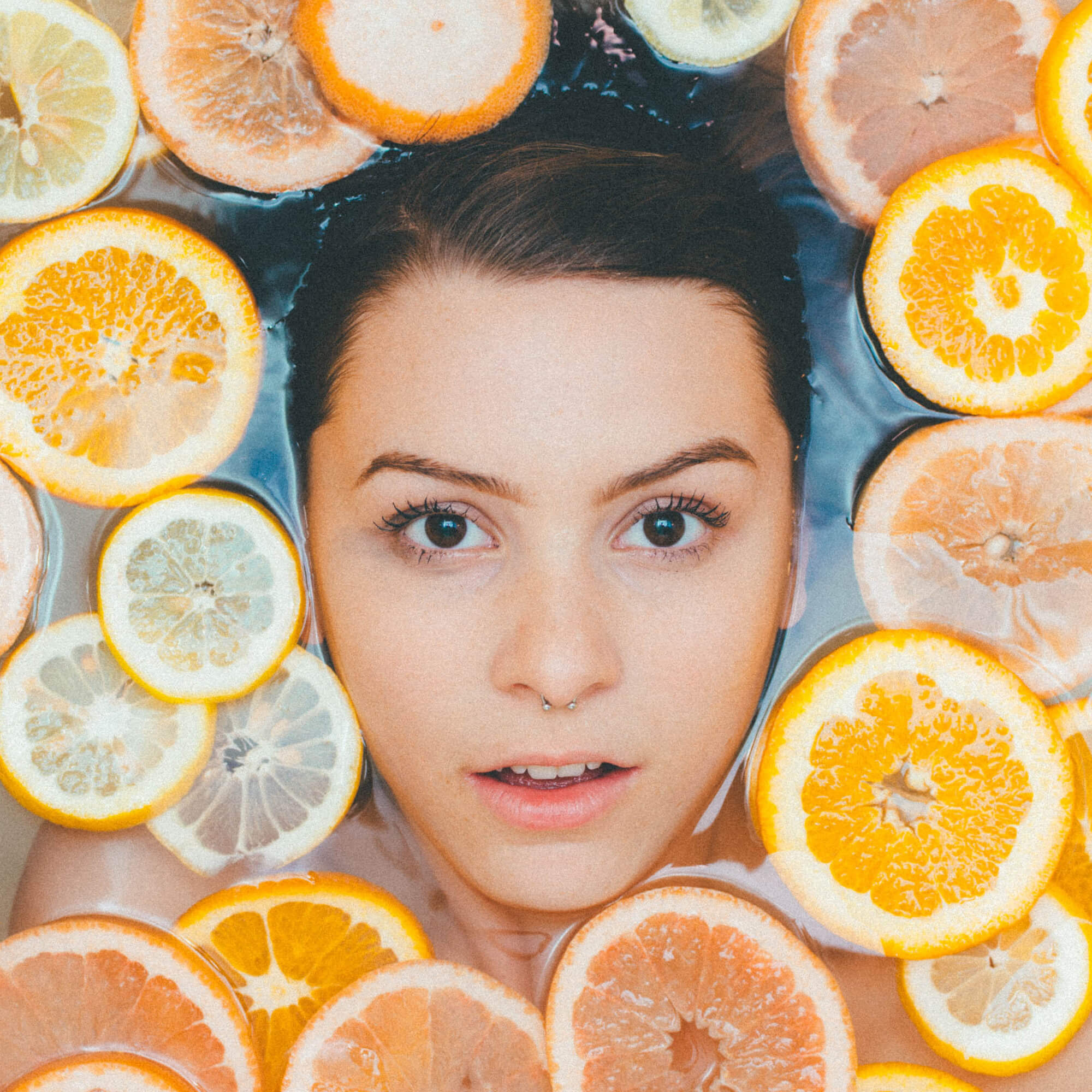 girl in water with citrus slices